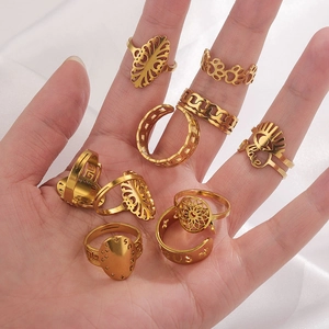 Minimalist gold stainless steel open ring set with leaf and geometric patterns on white silk