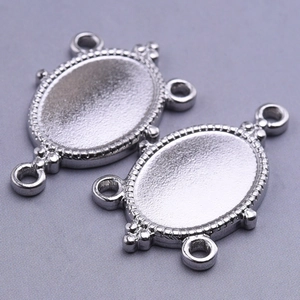 Detailed macro view of 304 stainless steel oval jewelry connectors with beaded edges