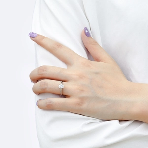 Close-up of a silver ring with an oval zircon stone featuring a classic four-prong setting