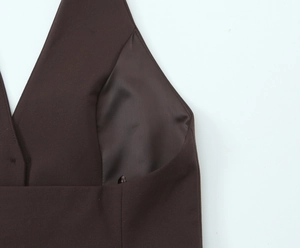 Detail of dark brown tank top featuring soft striped lining and V-neck tailoring