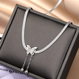 Detail of silver butterfly pendant necklace with matte finish on black leather jewelry box