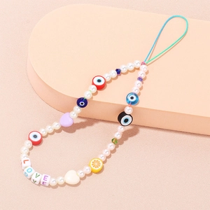 Colorful evil eye and pearl beaded phone strap with LOVE letter charms on pink background