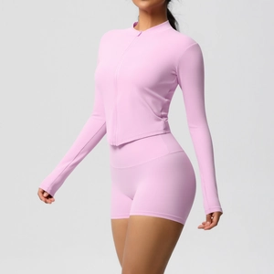 Detail view of pink high-elasticity yoga set with zip jacket and high-waist shorts