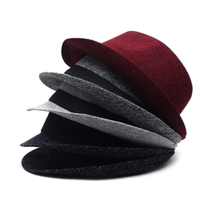 Detail showing various colors of men's jazz hats with fine textile texture and curled brim