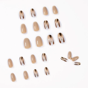 Glossy leopard print almond press-on nails set in milky tea color with gold foil flakes