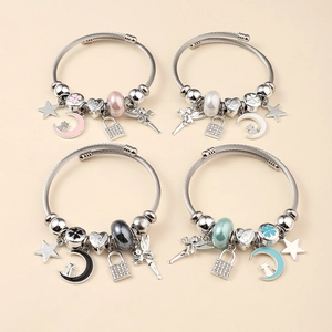 Detailed view of wire charm bracelets featuring star, moon, and heart-shaped pendants