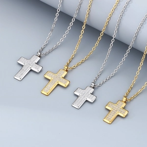Close-up of gold and silver cross pendants with full-inlay cubic zirconia stones