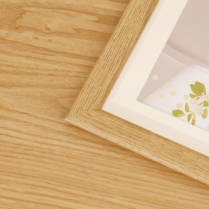 Nordic minimalist light wood frame with cream mat board and botanical art detail