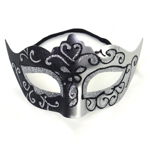 Close-up of masquerade mask featuring black and silver sequins with intricate floral patterns