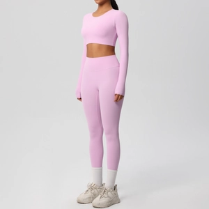 Detail of pink long-sleeve crop top and high-waisted yoga leggings set for fitness