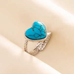 Detailed macro of silver twist ring with heart-shaped blue turquoise stone detail