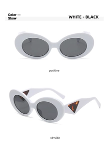 Detail view of white oval sunglasses with triangular tortoiseshell temple accents