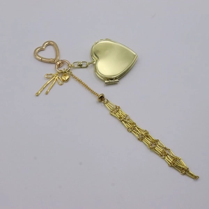 Golden heart-shaped keychain with tassel and bow pendant for handbag decoration