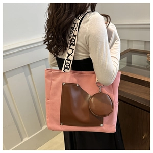 Pink canvas tote bag detail with brown leather pocket and round coin purse attachment