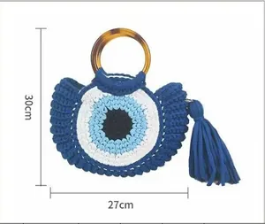 Detail showing shell-shaped woven bag dimensions with 30cm height and 27cm width
