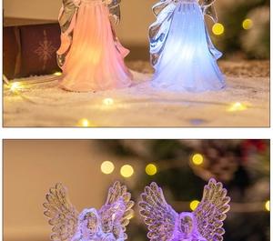 Close-up of glowing LED acrylic angel night lights in pink and blue festive colors