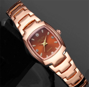 Detail of tonneau quartz watch with rose gold metal band and brown gradient dial
