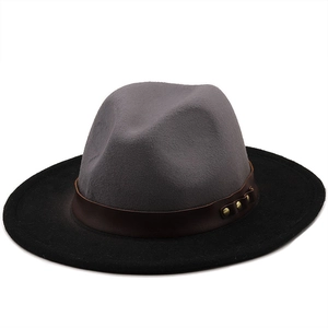Detail of felt fedora hat featuring two-tone grey crown and black brim with leather band