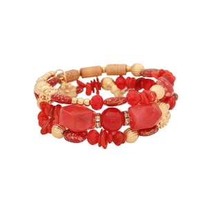 Bohemian multi-layer beaded bracelet featuring red stones and gold metal spacers