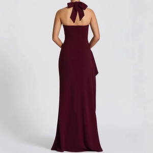 Elegant burgundy backless evening gown with a large bow tie and side slit detail