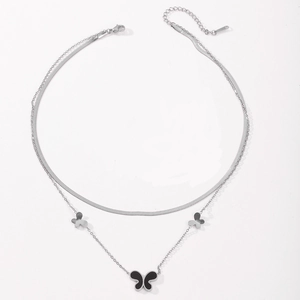 Detail view of double-layer stainless steel necklace featuring silver butterfly pendants