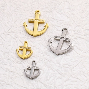 Detailed view of anchor pendants in gold and silver finish with crystal accents