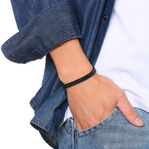 Detail of man wearing black woven double-row curb chain bracelet with casual outfit