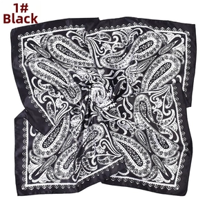Detailed close-up of a 90x90cm black and white paisley satin square scarf with wavy edges