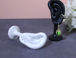 Vertical black and horizontal white silicone ear displays for jewelry photography