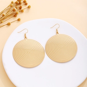 Detailed view of vintage gold round stud earrings with concentric dotted texture design
