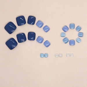 Glossy Klein blue and white press-on toenails set in various sizes for a modern pedicure