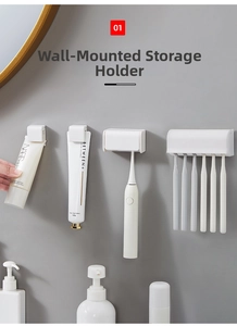Detail view of wall-mounted white plastic clips for organizing toothbrushes and toothpaste