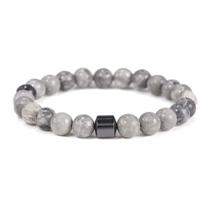 Macro detail of 8mm gray marble stone beads with a black metallic cylinder on the bracelet