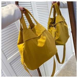 Mirror view of yellow nylon tote bag showing spacious design and adjustable shoulder strap