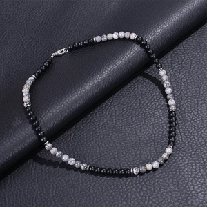 Detail of 6mm natural map stone beaded necklace with lobster clasp on black leather