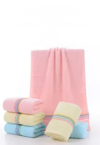 Detailed close-up of fluffy cotton towels with soft low-twist loops and colorful stripes