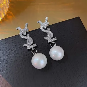 Silver needle earrings with sparkling VSL letters and large round white pearls