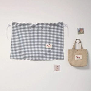 Detailed view of grey checkered car sunshade with suction cups and lanyard hanging