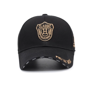 Classic black cotton baseball cap with gold shield embroidery and decorative brim prints