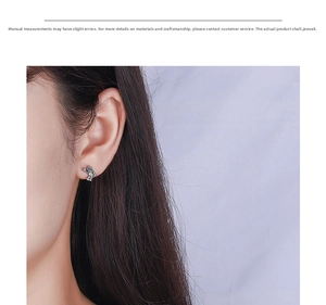 Close-up of a model wearing a creative blue astronaut stud earring with vintage finish
