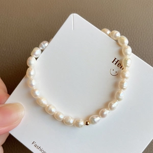 Minimalist natural freshwater pearl bracelet with 14K gold-filled bead on white card