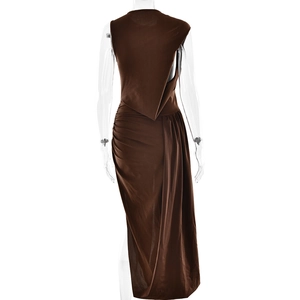Detail view of brown sleeveless dress featuring back pleats and irregular hem design