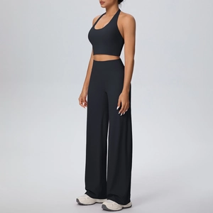 Detail of black halter yoga set showing the high-stretch fabric of the sports bra and pants