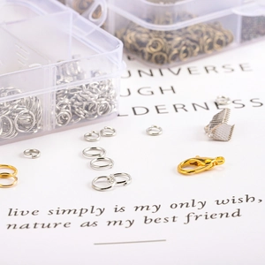 DIY jewelry making kit with lobster clasps and jump rings in a clear storage box