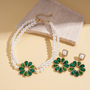Detail of baroque pearl double necklace and green crystal floral earrings set