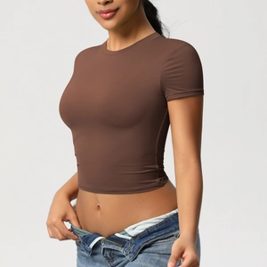 Close-up of tight coffee brown sports t-shirt with crew neck and cropped design