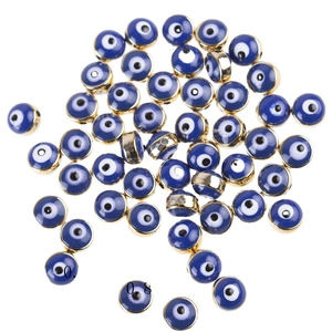 Flat lay of 8x5mm gold-rimmed blue resin Evil Eye beads for DIY jewelry making