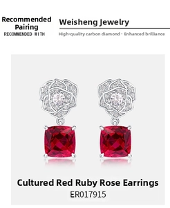 Detail of cushion-cut lab ruby earrings with silver rose design and sparkling accents
