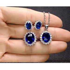 Detailed view of Diana style blue crystal jewelry set with halo diamond setting