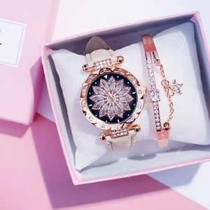 Close-up of rose gold watch with rhinestone dial and star bracelet in a gift box